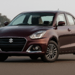 Maruti Suzuki Dzire 2025 मॉडल सफेद रंग में सड़क पर खड़ी हुई – कंपनी ने नई फेस्टिव ऑफर्स और कीमतों में कटौती की घोषणा की।