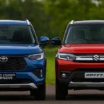 Maruti Brezza vs Toyota Urban Cruiser Taisor 2025 High-resolution image showing Maruti Suzuki Brezza vs Toyota Urban Cruiser Taisor side by side, highlighting both SUVs with their logos clearly visible.