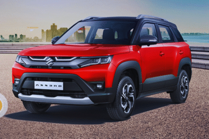 Maruti Suzuki Brezza 2025 parked on an open road with modern LED headlights and dual-tone design — showcasing the SUV’s bold look, premium interior, and Smart Hybrid badge.”